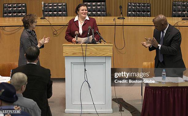 Jamie Ayers, a former prisoner in the Massachusetts Department of Corrections system, receives a standing ovation after her speech during a press...