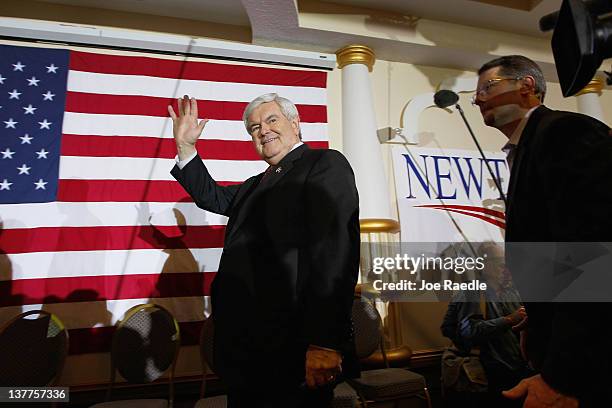 Republican presidential candidate and former Speaker of the House Newt Gingrich waves as he leaves a campaign event at a Space Coast Town Hall...