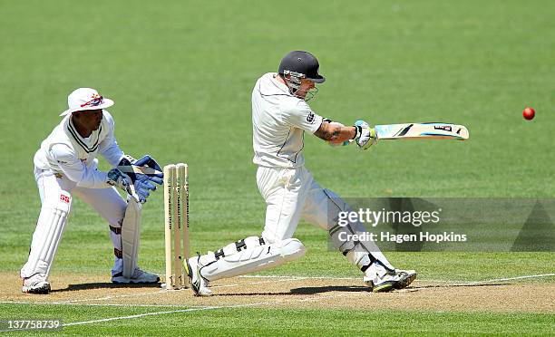 Brendon McCullum of New Zealand hits out while Tatenda Taibu of Zimbabwe looks on during day one of the test match between New Zealand and Zimbabwe...