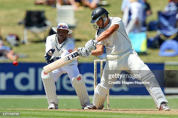 Ross Taylor of New Zealand bats while Tatenda Taibu of Zimbabwe looks on during day one of the test match between New Zealand and Zimbabwe at McLean...