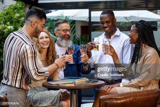 toasting to success - happy hour stockfoto's en -beelden