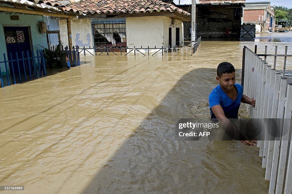 A youngster wades through a flooded stre