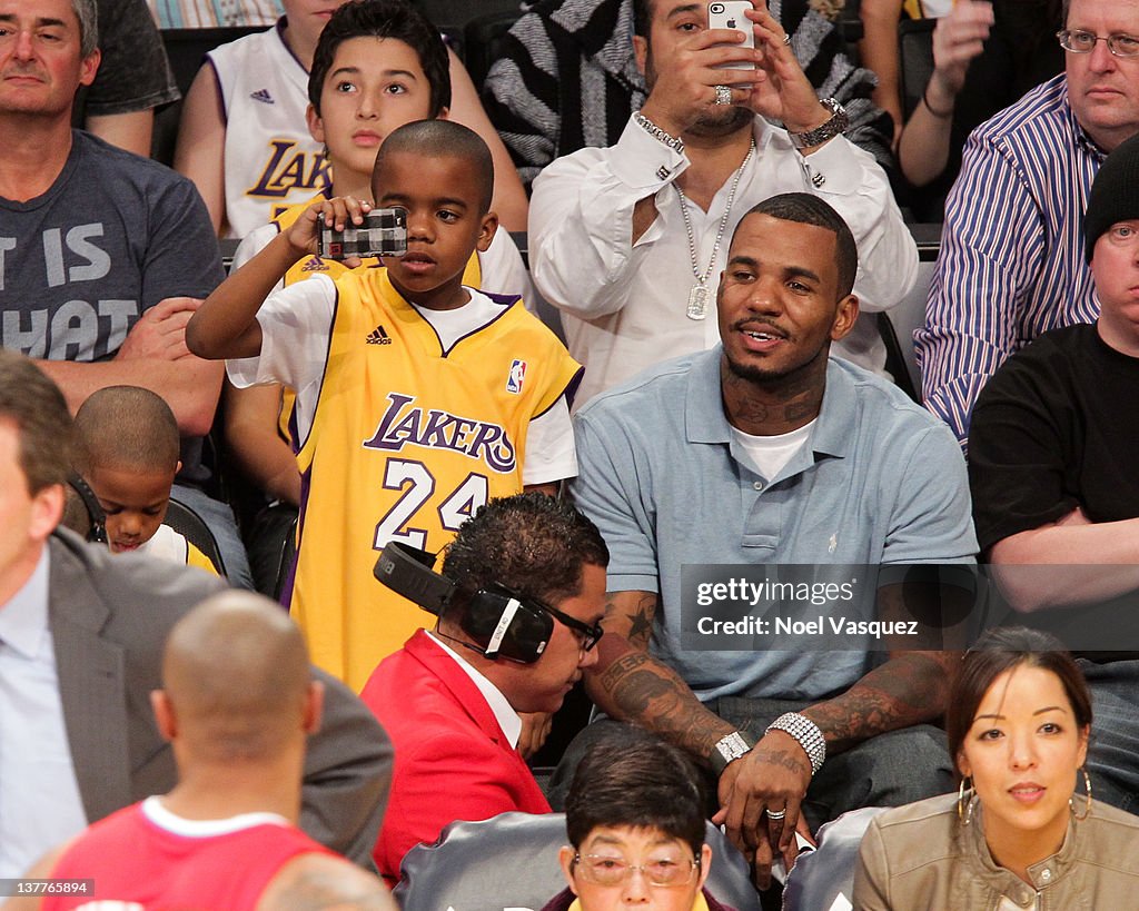 Game and his son Harlem Caron Taylor attend a game between the Los