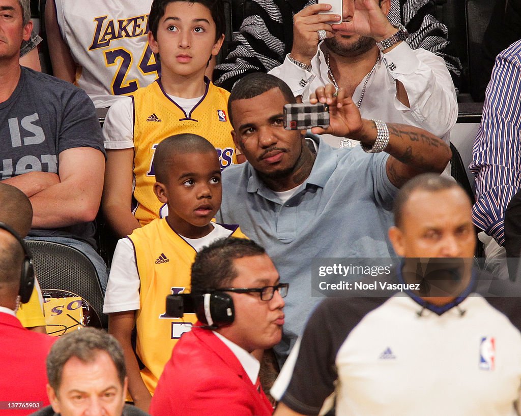 Game and his son Harlem Caron Taylor attend a game between the Los