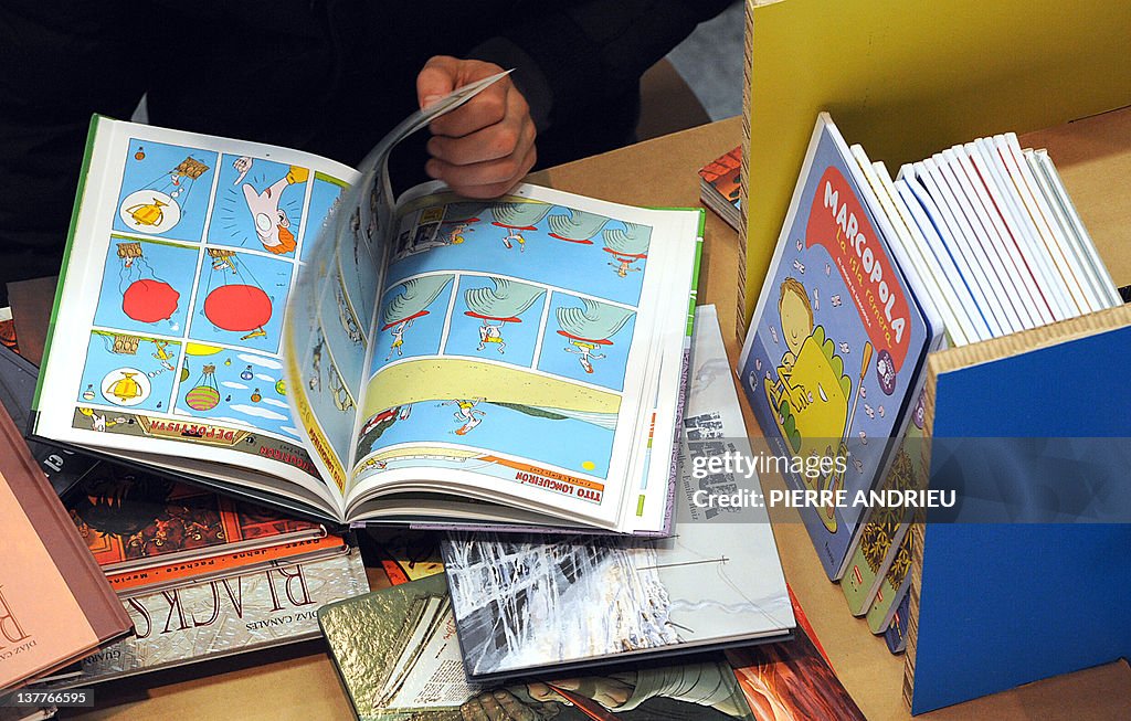 A man reads comics displayed at the 39th