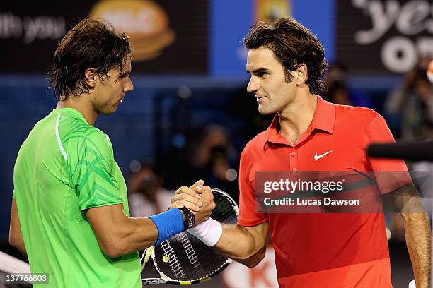 Roger Federer of Switzerland and Rafael Nadal of Spain embrace at the net after their semifinal match during day eleven of the 2012 Australian Open...