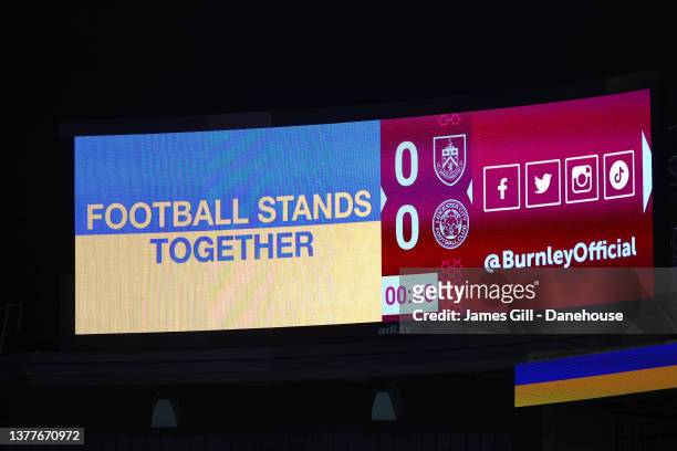 Ukraine flags are seen displayed on LED boards during the Premier League match between Burnley and Leicester City at Turf Moor on March 01, 2022 in...