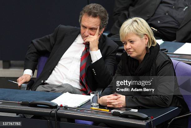 Die Linke party co-Chairwoman Gesine Loetzsch and Die Linke party co-Chairman Klaus Ernst listen while sitting in the German parliament Bundestag on...