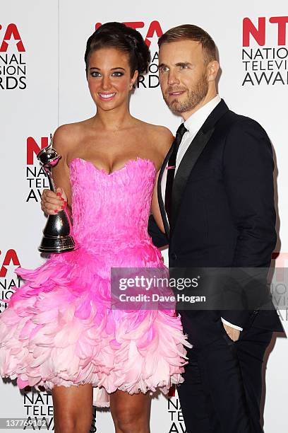 Tulisa Contostavlos and Gary Barlow pose with their Best Talent Show Award for X-Factor in the press room at the National Television Awards 2012 at...