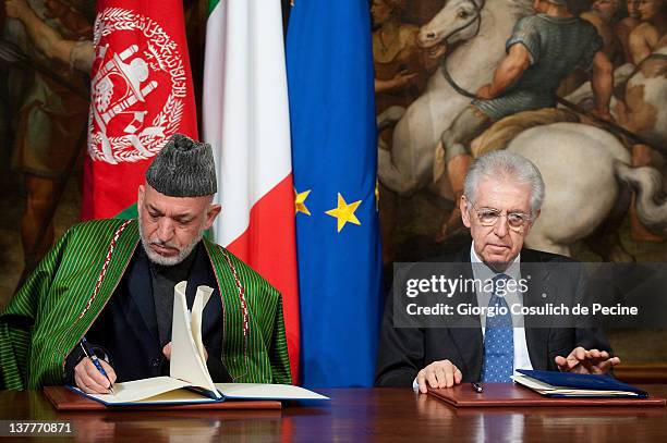 Afghan President Hamid Karzai and Italian Prime Minister Mario Monti sign a bilateral agreement on cooperation and partnership, at Palazzo Chigi on...