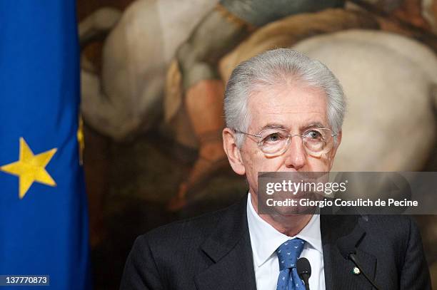 Italian Prime Minister Mario Monti attends a meeting with Afghan President Hamid Karzai to sign a bilateral agreement on cooperation and partnership,...