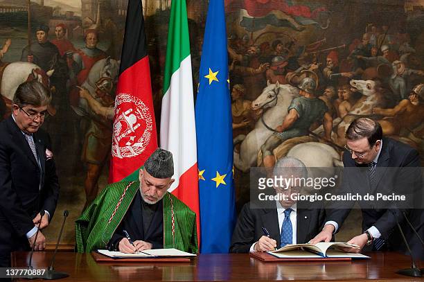 Afghan President Hamid Karzai and Italian Prime Minister Mario Monti sign a bilateral agreement on cooperation and partnership, at Palazzo Chigi on...