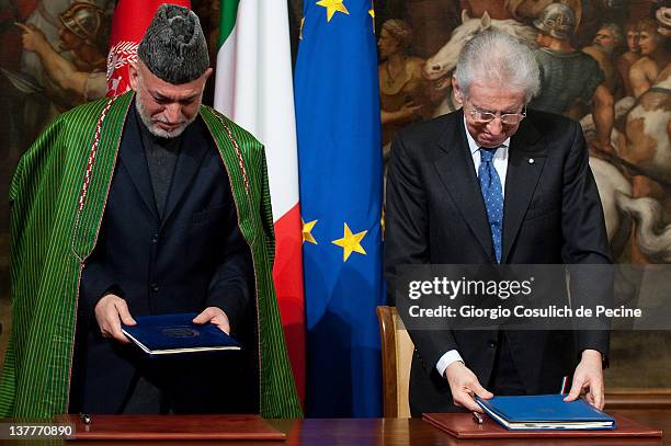 Afghan President Hamid Karzai and Italian Prime Minister Mario Monti sign a bilateral agreement on cooperation and partnership, at Palazzo Chigi on...