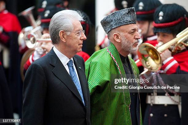 Italian Prime Minister Mario Monti and Afghan President Hamid Karzai parade in front of the guard of honor as they arrive to attend an official...