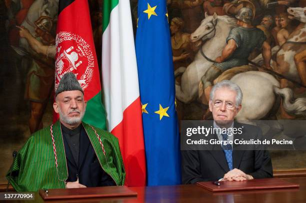 Afghan President Hamid Karzai and Italian Prime Minister Mario Monti attend a meeting to sign a bilateral agreement on cooperation and partnership,...