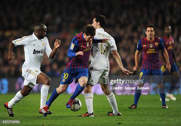Lionel Messi of FC Barcelona tries to play the ball past Alvaro Arbeloa of Real Madrid in between during the Copa del Rey quarter final second leg...