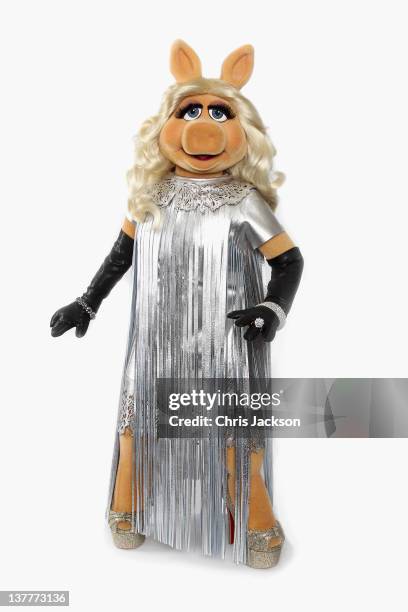 Miss Piggy debuts her dress designed by Giles Deacon for the UK premiere of The Muppets this evening at The Mayfair Hotel on January 26, 2012 in...