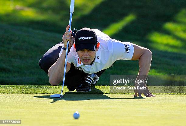 Camilo Villegas of Colombia checks his putt on the 12th hole on the North Course during the first round of the Farmers Insurance Open at Torrey Pines...