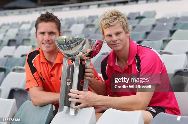 Team captains Marcus North of the Perth Scorchers and Steve Smith of the Sydney Sixers pose with the T20 trophy during the Big Bash League Final...