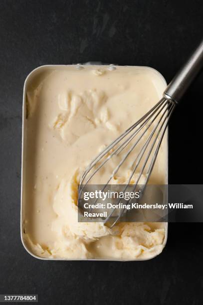 making ice cream, step 2: creme anglaise in freezer-proof dish, breaking up ice crystals with a whisk - homemade icecream stock pictures, royalty-free photos & images