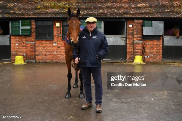 Trainer, Paul Nicholls poses with Bravemansgame during a stable visit ahead of the Cheltenham Festival at Manor Farm Stables on March 03, 2022 in...