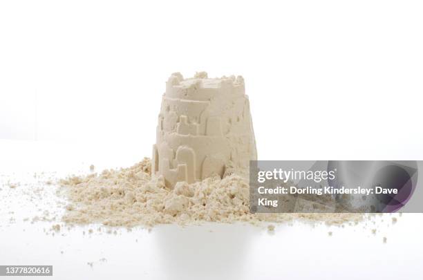 child making sandcastles and playing with sand, windmills - zandkasteel stockfoto's en -beelden