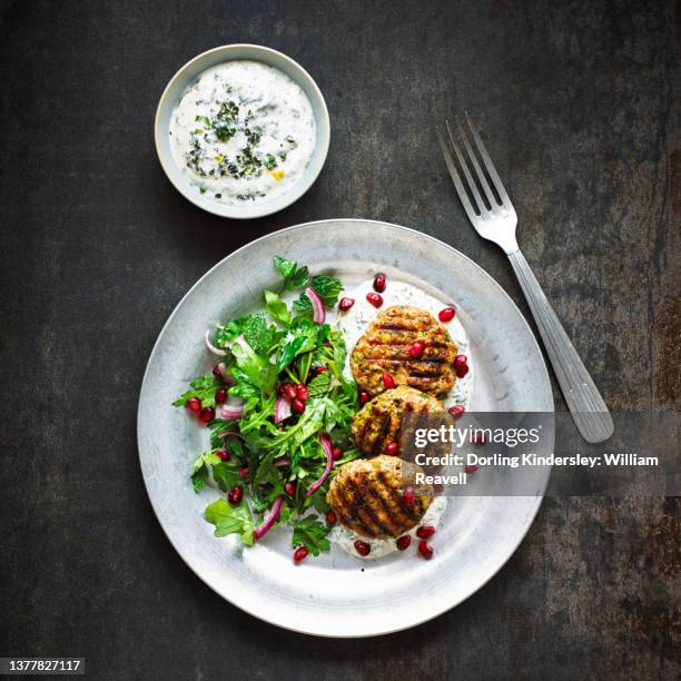 turkey koftes with citrus greek yogurt, pomegranate and herb salad - turkey meat balls stock pictures, royalty-free photos & images