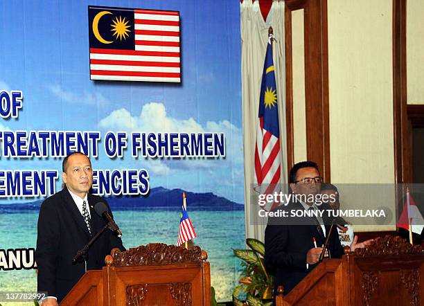 Malaysia's minister in the Prime Minister's Department Mohamed Nazri Abdul Aziz listens to Indonesian Coordinating Minister for Politics, Law and...