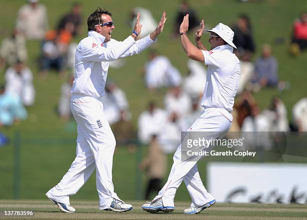 Graeme Swann of England celebrates with captain Andrew Strauss after dismissing Taufeeq Umar of Pakistan during the second Test match between...