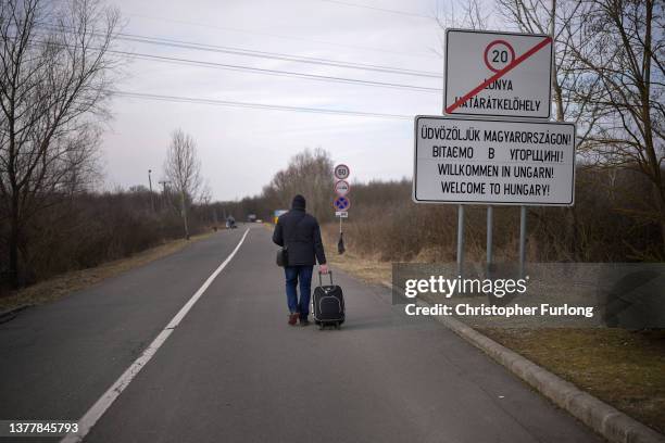 Ukrainian refugee walks along the road after walking across the border at the Hungarian town of Lonya on March 03, 2022 in Lonya, Hungary. Over one...