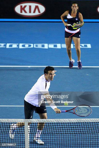 Daniele Bracciali of Italy plays a backhand in his semifinal mixed doubles match with Roberta Vinci of Italy against Leander Paes of India and Elena...