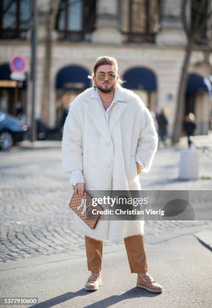 Justus Toussis wearing STAND STUDIO White Faux-fur Coat double breasted , TOM FORD sean mirrored aviator sunglasses gold brown, YVES SAINT LAURENT...