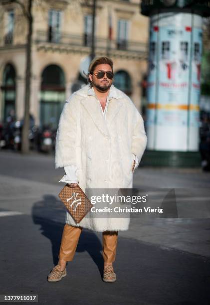 Justus Toussis wearing STAND STUDIO White Faux-fur Coat double breasted , TOM FORD sean mirrored aviator sunglasses gold brown, YVES SAINT LAURENT...