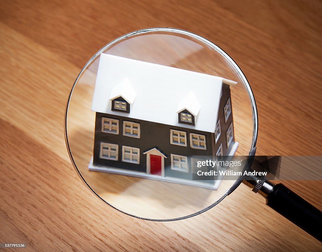House scrutinized by magnifying glass