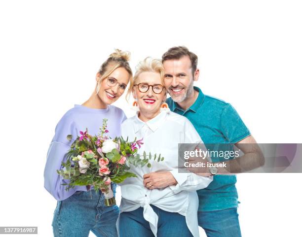 woman with son and daughter-in-law holding bouquet - daughter in law stock pictures, royalty-free photos & images