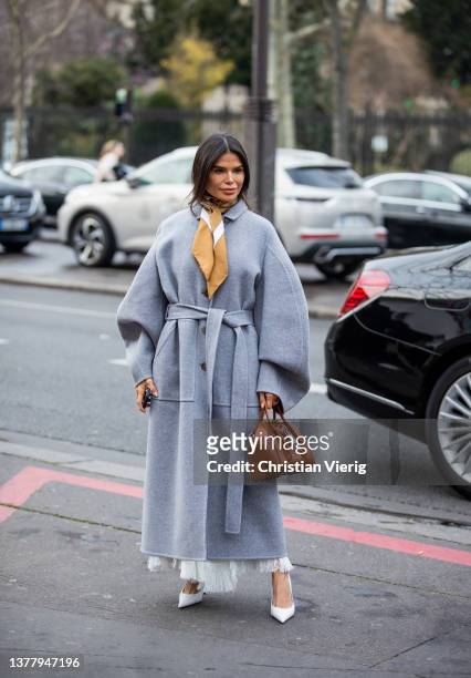 Victoria Barbara seen wearing grey belted oversized coat, brown bag, white heels outside Cecilie Bahnsen during Paris Fashion Week - Womenswear F/W...