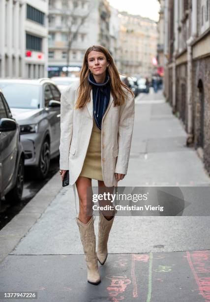 Monica de La Villardiere seen wearing striped navy turtleneck, beige dress, oversized latte blazer, mid knee cowboy boots in beige outside Acne...