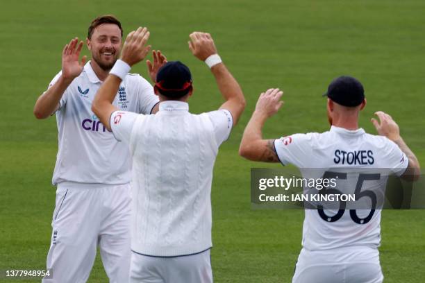 England's Ollie Robinson celebrates with teammates after taking the wicket of Australia's Cameron Green on day four of the second Ashes cricket Test...