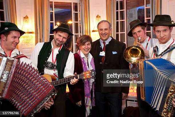 Founder Steffi Czerny and Clemens Boersig, chairman of Deutsche Bank AG pose with bavarian musicians during the Burda DLD Nightcap 2011 at the...