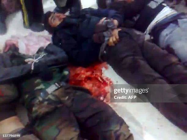 An image grab taken on December 23, 2011 from a video uploaded on YouTube shows the handcuffed bodies of Syrian men who were allegedly killed along...