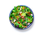 Healthy fresh green salad plate shot from above on white background