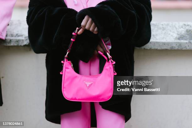 Guest poses with a Guess pink fluo bag after the Coperni show during Paris Fashion Week - Womenswear F/W 2022-2023 on March 03, 2022 in Paris, France.