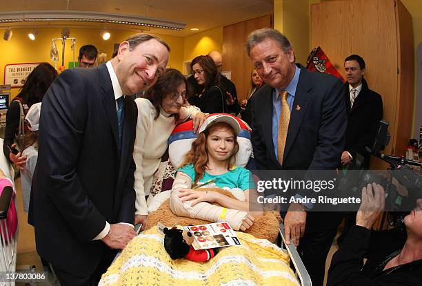 Commissioner Gary Bettman and Owner, governor and chairman Eugene Melnyk of the Ottawa Senators visits with a young patient at the unveiling of the...