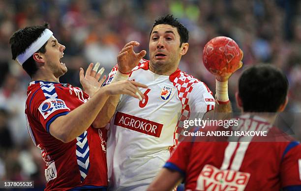 Croatia's Blazenko Lackovic vies with Serbia's Alem Toskic and Serbia's Bojan Beljanski during the men's EHF Euro 2012 Handball Championship...