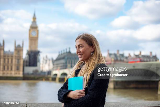 happy female student in london - exchange student stock pictures, royalty-free photos & images