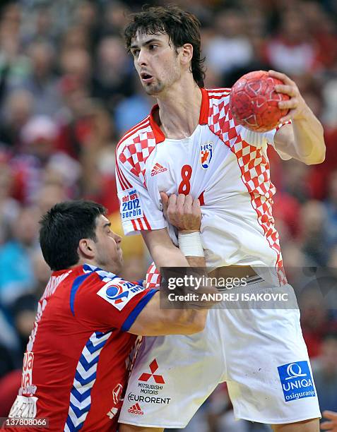 Croatia's Marko Kopljar vies with Serbia's Nenad Vuckovic during the men's EHF Euro 2012 Handball Championship semifinal match Serbia vs Croatia on...