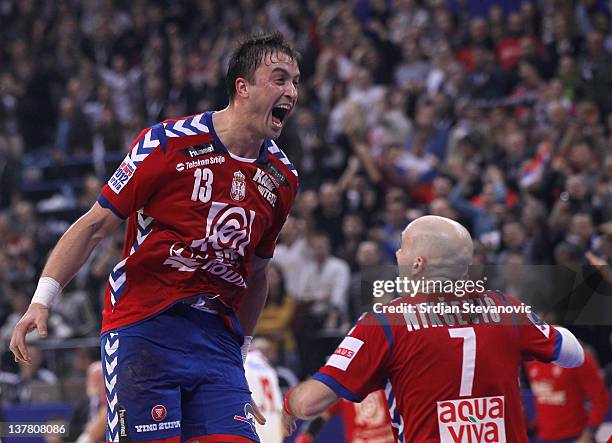 Momir Ilic and Ivan Nikcevic of Serbia celebrate victory against Croatia during the Men's European Handball Championship 2012 semifinal match between...