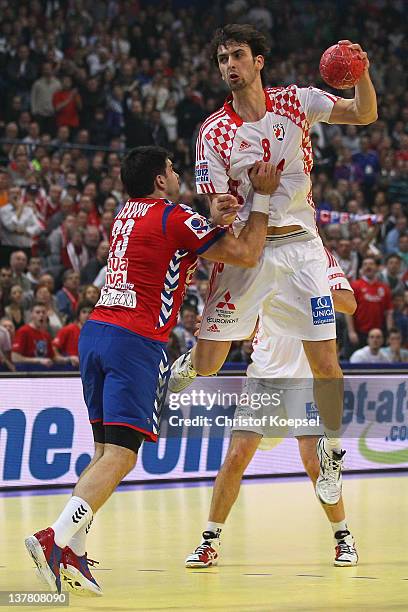 Nenad Vuckovic of Serbia defends against Marko Kopljar of Croatia during the Men's European Handball Championship second semi final match between...