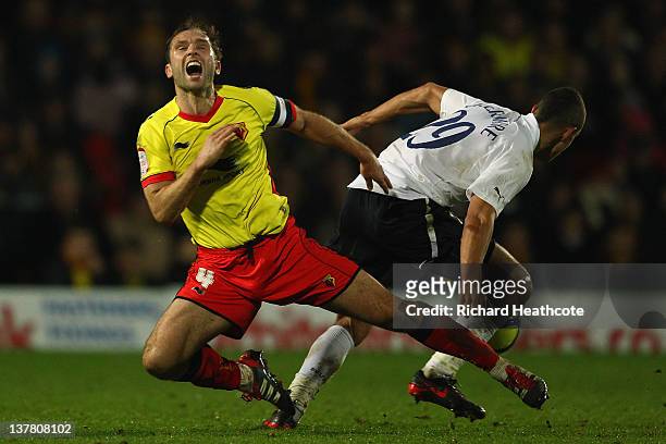 John Eustace of Watford and Jake Livermore of Spurs clash during the FA Cup Fourth Round match between Watford and Tottenham Hotspur at Vicarage Road...
