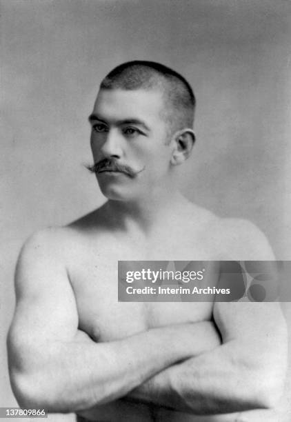 Portrait of the boxer John Lawrence Sullivan , heavyweight boxing champion, with arms folded across his chest, late nineteenth century.